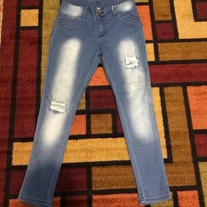 Skinny distressed jeans w/straight pant legs down to ankle.